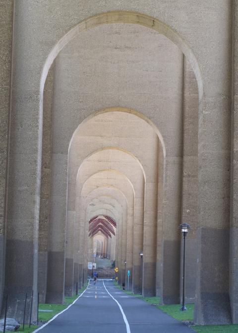 A long hallway with arches and columns in it