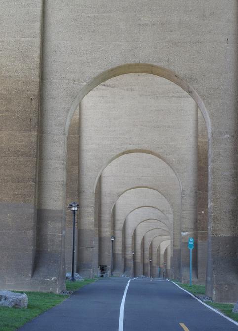A long row of arches in the middle of an alley.
